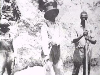 Inmates holding work tools.