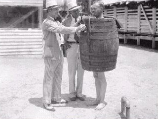 Man with weighted barrell around him.