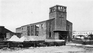 Brick building with no roof, doors, or windows.