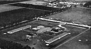 Ariel view of farm land and sprawl of buidlings.