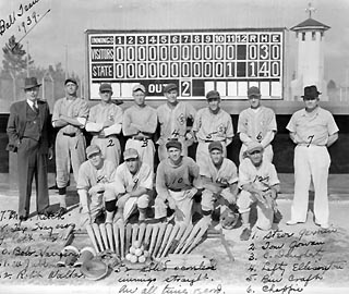 Thirteen men, 12 in baseball uniforms another (unidentified) in a suit.