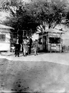 Group of people passing through gate.