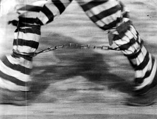 Feet and lower legs of inmate with leg irons