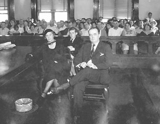 Mother, father and brother sitting in front of 4-5 rows of jury observers.