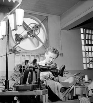 Woman assembling shirts in the sewing rom