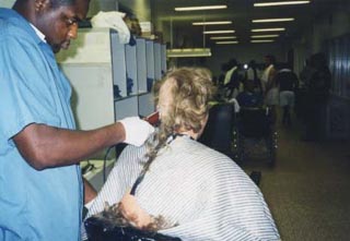 Inmate receiving hair cut during reception process.