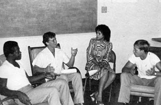 Counselor sitting in circle with three inmates