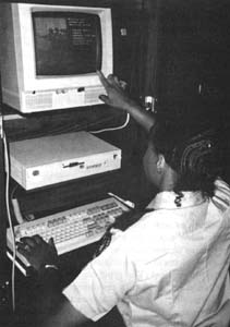 Female officer operating a touch screen computer.