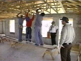 Inmates constructing a building