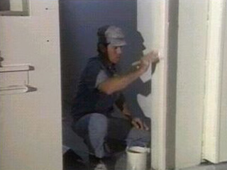 Inmate Painting the Wall