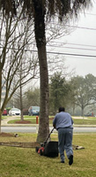 Photo of inmate pushing a lawn mower