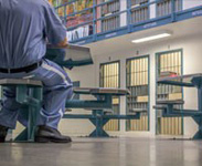 Inmates sitting at tables