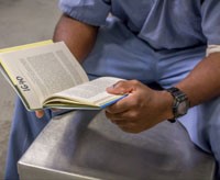 Inmate holding a book.